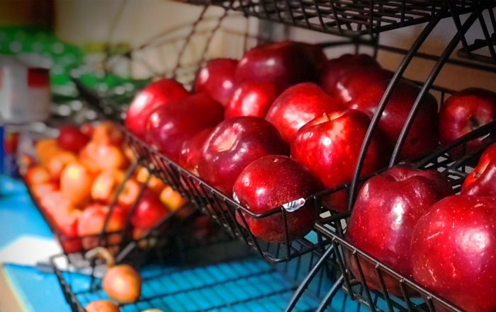 A basket of apples in a food shelf