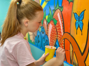Rosemount High School Student paints at 360 Communities Rosemount Resource Center