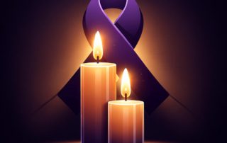 Two lit candles with a purple ribbon.