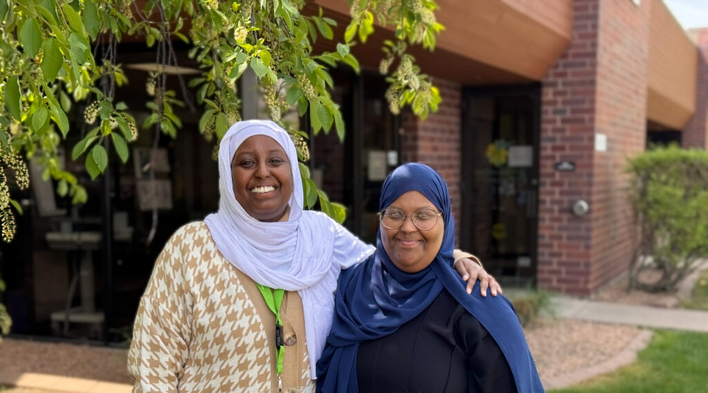 Public health interns Sumayo and Hodo at the 360 Communities Burnsville Resource Center and food shelf
