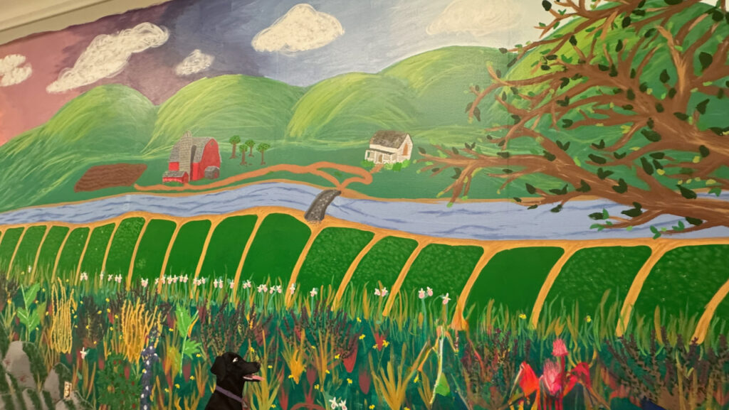 Burnsville High School students painting a colorful mural at the 360 Communities Burnsville food shelf