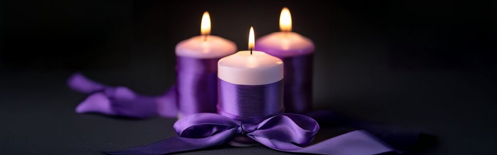 Three candles representing remembrance and support for victims of domestic violence